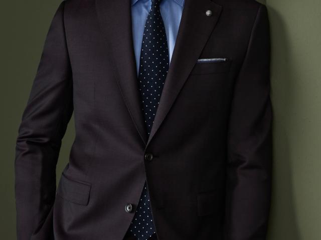 Adam Senn wearing a suit and tie